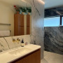 Bathroom with marble-look panels and painted in Resene Wheatfield