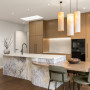 Kitchen featuring walls and lacquered island in Resene Half Wan White