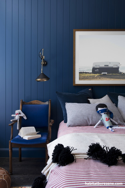 An inky, navy blue encompasses children's bedroom