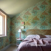 Wallpaper creates exiting outdoors atmosphere in bedroom