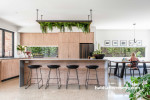 Kitchen in bright white tones balanced with natural wood paneling 