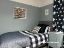 Light grey blue tone creates calming atmosphere in bedroom