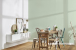 Dining space with gentle green wallpaper 