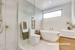 White tones painted on walls and ceiling creates enchanting space in this powder room