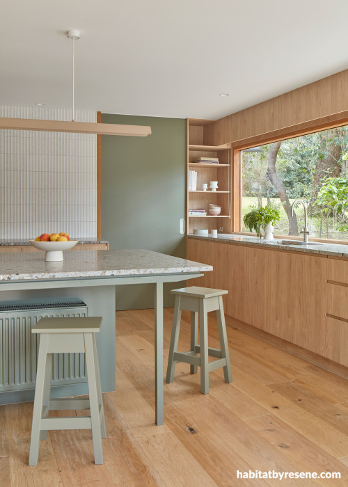 Kitchen with timber features, and painted in Resene Double Lemon Grass and Resene Quarter Thorndon Cream