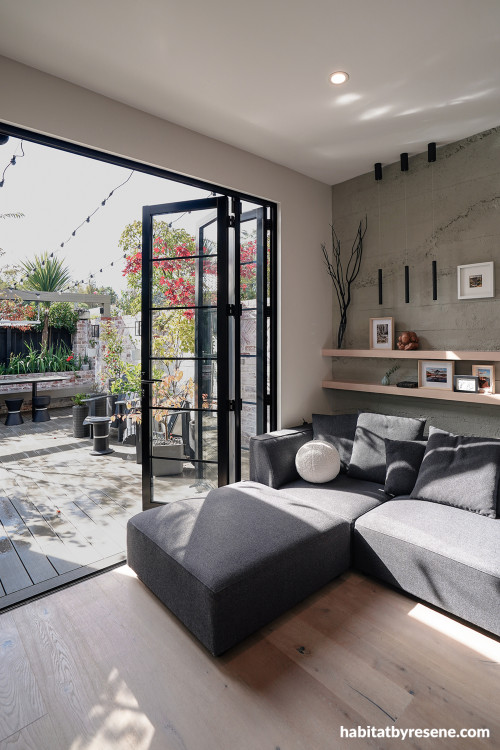 Living room featuring roughcast concrete panels and painted in Resene White Pointer