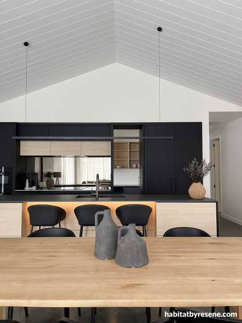 Open plan kitchen, kitchen featuring black, white and timber