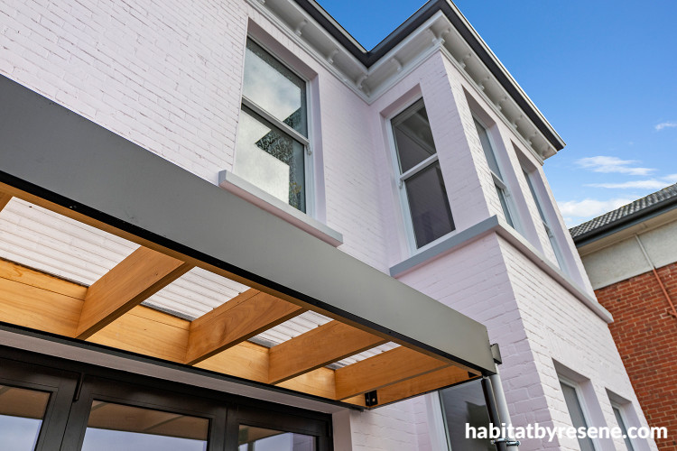 House exterior painted in Resene Sauvignon with details in Resene Black