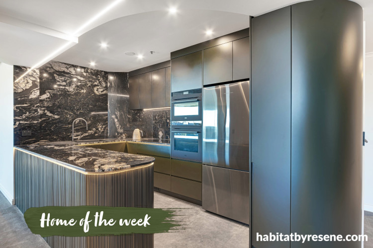 Kitchen featuring cabinets painted in Resene Midnight Moss and living area walls in Resene Quarter Truffle