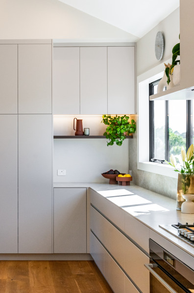 Warm neutrals and blush hues bring this Oratia home to life