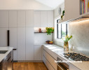 Kitchen cabinets painted in Resene AquaLAQ in Resene Truffle and ceiling in Resene Quarter Rice Cake