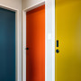Apartment doorways featuring mid-century inspired colours