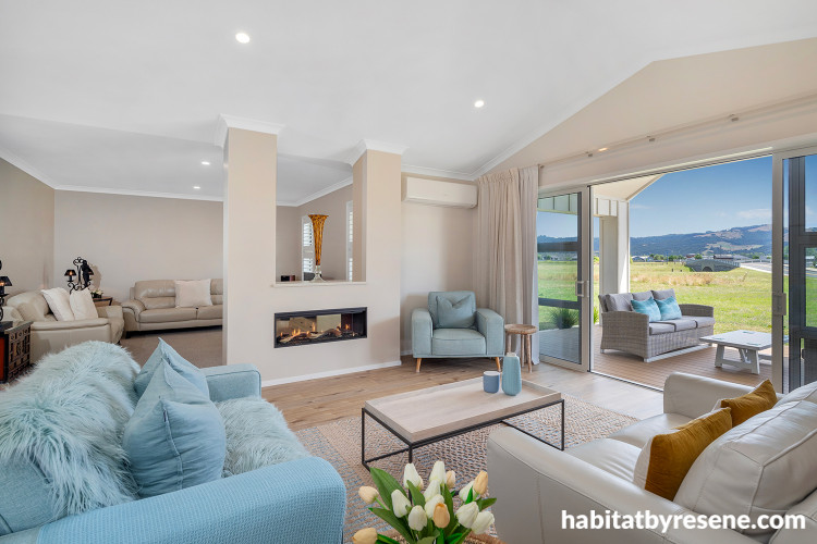 Living room featuring light beige walls painted in Resene Quarter Sandspit Brown and ceiling and trims in Resene Alabaster