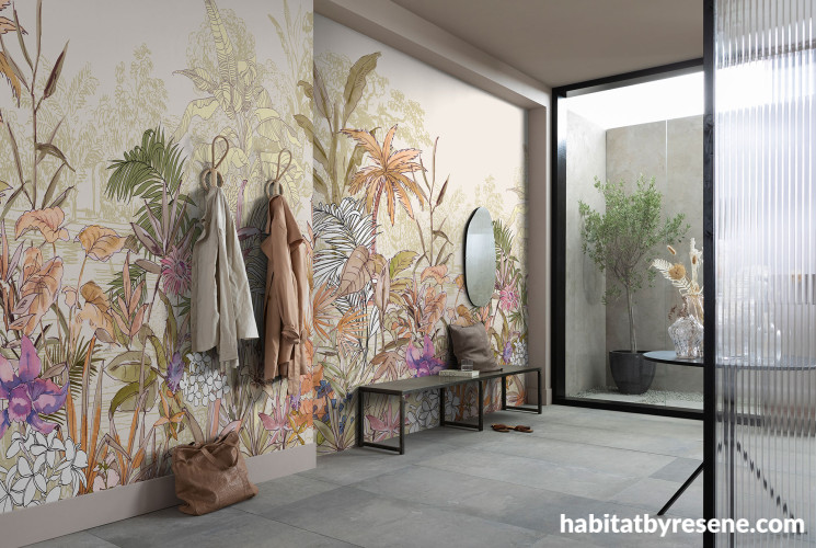 Entranceway featuring a nature mural-inspired wallpaper