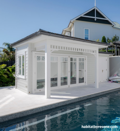 White pool house exterior painted in Resene Wan White with cladding in Resene Foggy Grey