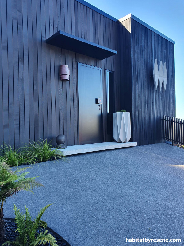 The stunning cedar exterior blends well into the natural surroundings, stained in Resene Woodsman Bushtrack with trims in Resene Pitch Black.  