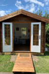 Two colourful SheSheds decorated with Resene