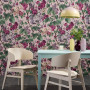 A dining room with floral wall paper