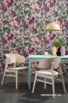 A dining room with floral wall paper