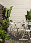 An outdoor dining set with plants