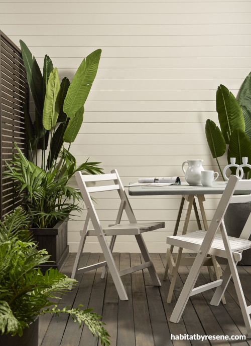 An outdoor dining set with plants