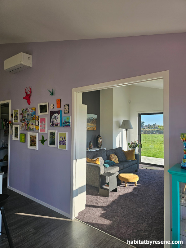 Living area featuring soft purple wall.
