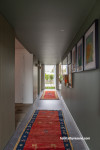 Hallway painted in refined green Resene Rivergum
