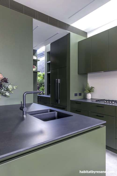 A green and black kitchen