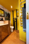 Art-loving couple’s industrial home brings art to life with yellow, red and Resene Half Black White