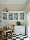 Kitchen in light tones and chequered floor 