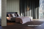 Bedroom featuring wallpaper with an elegant but subtle embossed pattern