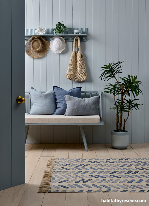 Outdoor patio featuring soft blue walls and timber flooring