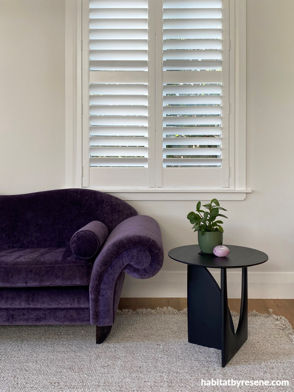 A vibrant purple rolled arm sofa in the living room has become a focal point, with the walls painted in Resene Sea Fog letting this piece shine.  