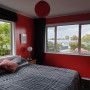 bedroom, red bedroom, master bedroom, red interior, red feature wall, bright bedroom