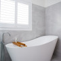 bathroom, grey bathroom, white bathroom, grey bathroom tiles, freestanding bath, resene alabaster 