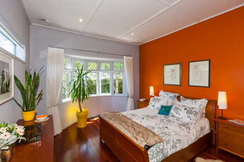 master bedroom, orange bedroom, orange feature wall, renovated villa, grey bedroom