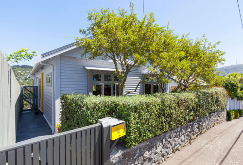 front exterior, house exterior, renovated villa, grey house, yellow front door