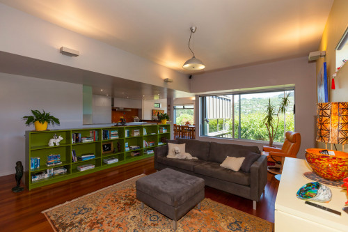 living room, lounge, renovated villa, grey living room, green bookshelf, grey paint