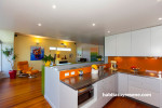 kitchen, dining room, orange splashback, bright kitchen, yellow feature wall, renovated villa 