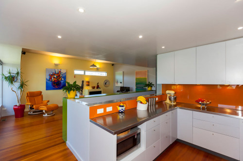 kitchen, dining room, orange splashback, bright kitchen, yellow feature wall, renovated villa