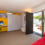 living area, lounge, yellow feature wall, white and yellow, renovated villa, yellow paint 