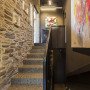 entranceway, stairwell, grey hallway, brown hallway, concrete floor, brick feature wall