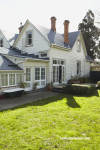 house exterior, green house, green painted weatherboards, neutrals, garden, white house 