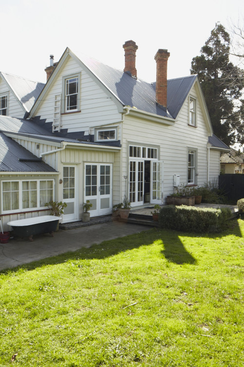 house exterior, green house, green painted weatherboards, neutrals, garden, white house