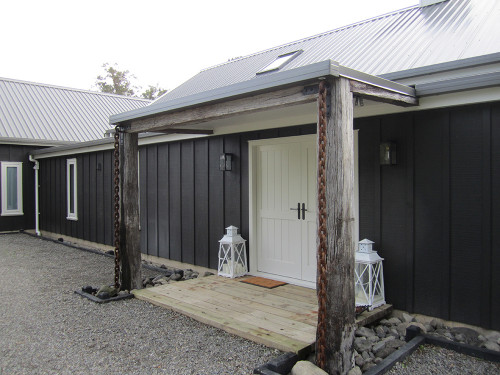 house exterior, barn style house, black house, black exterior, white front door, double front door