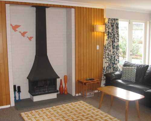 1970s home, retro house, retro lounge, living room, fireplace, painted brick, timber paneling