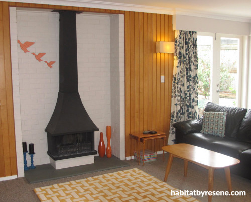 1970s home, retro house, retro lounge, living room, fireplace, painted brick, timber paneling 
