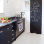 black and white kitchen, white kitchen tiles, black kitchen cabinetry, blackboard paint 