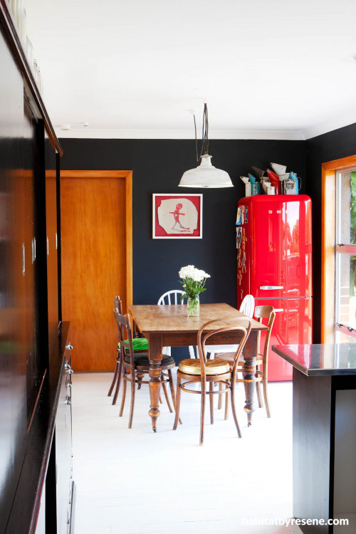 black dining room, open-plan dining, red fridge, black paint 