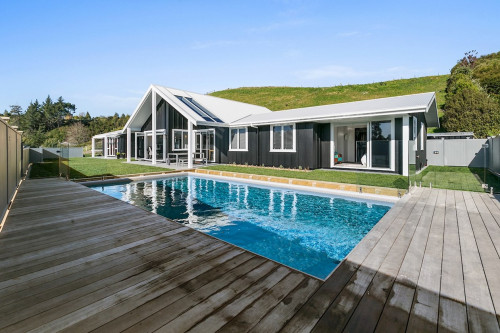 Black and white house, black exterior, white roof, pool, outdoor, deck, painting exterior